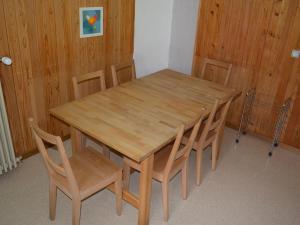 a wooden table and chairs in a room at Apartment Chalet Heureka-Horbis by Interhome in Engelberg