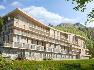 a large building with mountains in the background at Duplex 4 pièces Les Arcs 1600, Piscine, SPA, pied de pistes - FR-1-461A-7 in Arc 1600