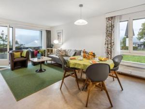 a living room with a yellow table and chairs at Apartment Residence Apt- 15 by Interhome in Wengen