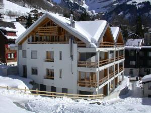 a building covered in snow with snow at Apartment Seelenmattli by Interhome in Engelberg