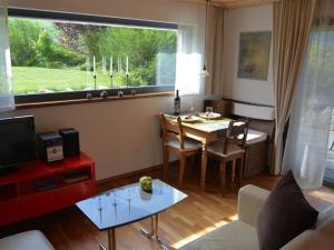 a living room with a table and a dining room at Apartment Bolzli-Hus by Interhome in Blankenburg +12 photos