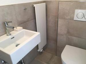 a bathroom with a sink and a toilet at Apartment Turmalin 2- Stock by Interhome in Lenk