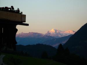 a view of a mountain range at sunset at Apartment Ferienhaus Niesen View by Interhome in Erlenbach im Simmental