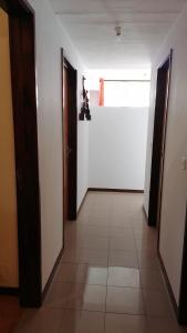 an empty hallway with two doors and a window at Madeira property in Câmara de Lobos +7 photos