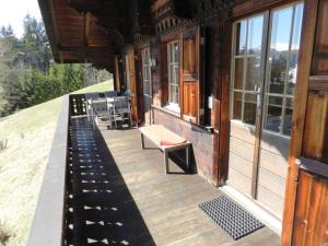a porch of a house with chairs and windows at Apartment Guex by Interhome in Hornkessel