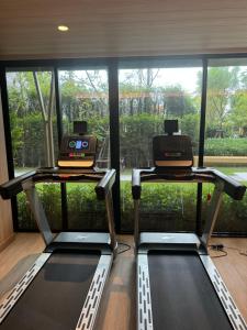 a gym with two treadmills in front of a window at Vuela Casa 2 in North Pattaya