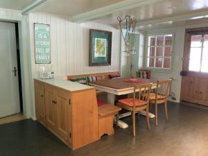 a kitchen and dining room with a table and chairs at Apartment Obegghuus by Interhome in Zweisimmen
