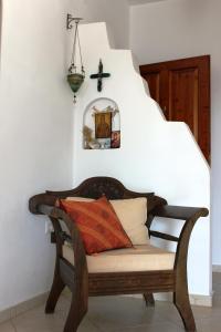a bench with pillows on it in a room at Galini in Agia Irini Milos