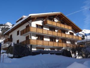 a building in the snow with snow at Apartment Alpenstrasse 1 by Interhome in Engelberg