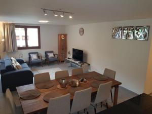 a living room with a wooden table and a dining room at Apartment Alpenstrasse 1 by Interhome in Engelberg +27 photos