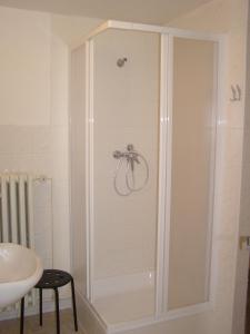 a shower stall in a bathroom with a sink at Hostel Praha Ládví in Prague