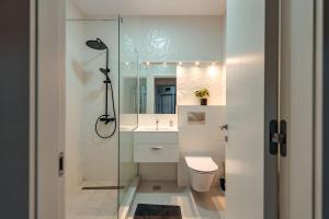 a bathroom with a shower and a toilet and a sink at Blvd Ivory Pipera ap 60A in Voluntari +32 photos
