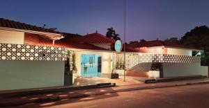 a house with a blue door on a street at Agualinda Hotel in Alter do Chao