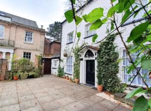 a large white house with a driveway in front of it at St Julians house in Shrewsbury