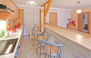 a kitchen with a counter and bar stools at Ferienwohnung Groß Plasten in Groß Plasten