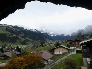 a view of a village with snow covered mountains at Apartment Chalet Waldchutz - Wohnung Anax by Interhome in Lenk