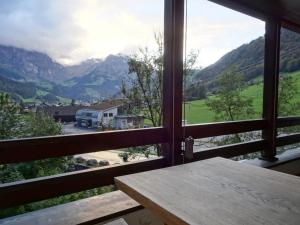 a room with a table and a view of a mountain at Apartment Am Dürrbach 5-545 by Interhome in Engelberg