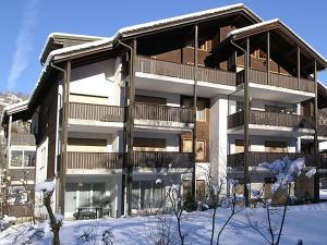 a apartment building with snow in front of it at Apartment Dorfstrasse 53c by Interhome in Engelberg