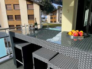 a table with a bowl of fruit on a balcony at Apartment Gerschnistrasse 10 by Interhome in Engelberg