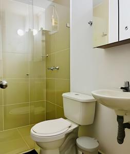 a bathroom with a toilet and a sink at 9804 · 9804 Loft Env. good view local experience confort in Envigado