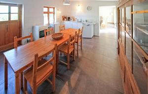 a large kitchen with a wooden table and chairs at Ehemaliges Farmhaus Lehsten in Lehsten