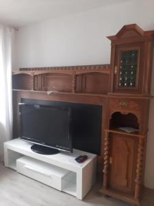 a entertainment center with a flat screen tv and a cabinet at FW 50 - Mitten in der historischen Altstadt mit Balkon in Görlitz