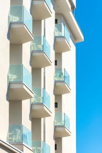 a facade of a building with glass balconies at Grand Meeting Hotel in Rimini