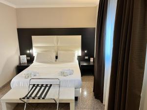 Postel nebo postele na pokoji v ubytování EH Suites Rome Airport Euro House Hotels + 15 fotografií