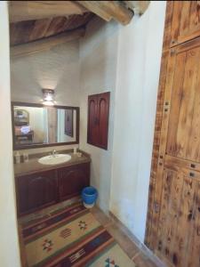 a bathroom with a sink and a mirror at Paloma Lodge Guest House in Siwa