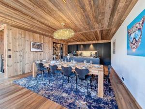 a dining room with a long table and chairs at Chalet La Panthère des Neiges in Saint-Martin-de-Belleville +7 photos