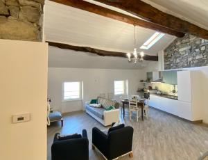 a living room with a couch and a table at Casa Hygge Argegno Lago di Como in Argegno