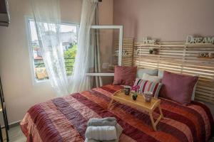a bedroom with a large bed with a table on it at Luxury rooftop in Larisa