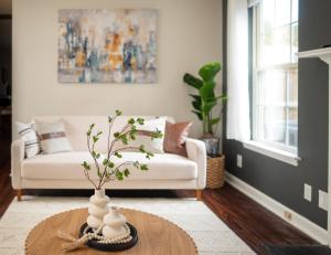 a living room with a white couch and a table at Entire home in RTP near Duke with fenced backyard in Durham