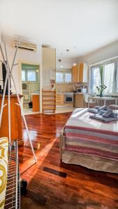 a bedroom with a large bed and a kitchen at La voce del porto in Ancona