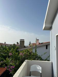 a white chair sitting on the ledge of a balcony at MAR VERDE - Parede-Cascais in Parede