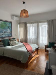 a bedroom with a large bed and a pendant light at MAR VERDE - Parede-Cascais in Parede +37 photos