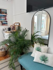 a living room with a mirror and a couch at MAR VERDE - Parede-Cascais in Parede
