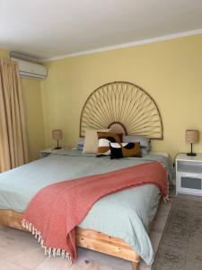 a bedroom with a large bed with a large wooden headboard at MAR VERDE - Parede-Cascais in Parede