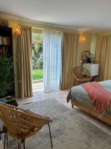 a bedroom with a bed and a large window at MAR VERDE - Parede-Cascais in Parede