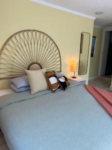 a bedroom with a large blue bed with pillows at MAR VERDE - Parede-Cascais in Parede