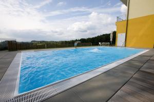 a large blue swimming pool on top of a building at Hotel Liebmann in Lassnitzhöhe