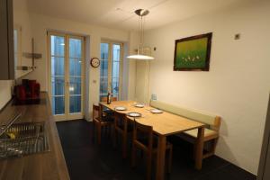 a dining room with a wooden table and chairs at Altbautraum am Gärtnerplatz 120 m2 in Munich