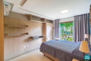 a bedroom with a bed and a window at Ykutiba Imbassaí - Apartamento Superior - I103 in Imbassai +24 photos