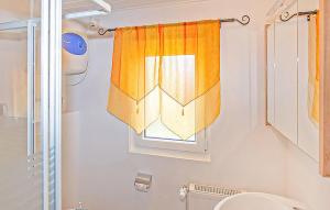 a bathroom with a shower curtain and a window at Ferienhaus Wiek Auf Rügen in Wiek auf Rügen  +8 photos