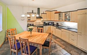 a kitchen with a wooden table and some chairs at Ferienwohnung Zirtow in Mirow
