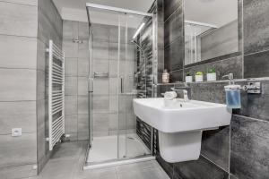 a bathroom with a sink and a shower at KORZO Lipno in Lipno nad Vltavou +142 photos