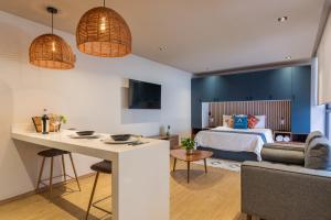 a bedroom with a bed and a desk in a room at Be Local in Mexico City +70 photos