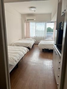 Postel nebo postele na pokoji v ubytování 蕨北野マンションWarabi Mansionー無料駐車場付き