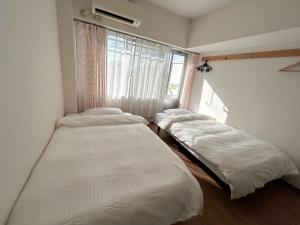 Postel nebo postele na pokoji v ubytování 蕨北野マンションWarabi Mansionー無料駐車場付き