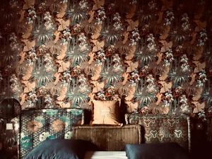 a room with a wall with a floral wallpaper at Villa Anna Splendid Sunset Ocean Front in Mosteiros +42 photos
